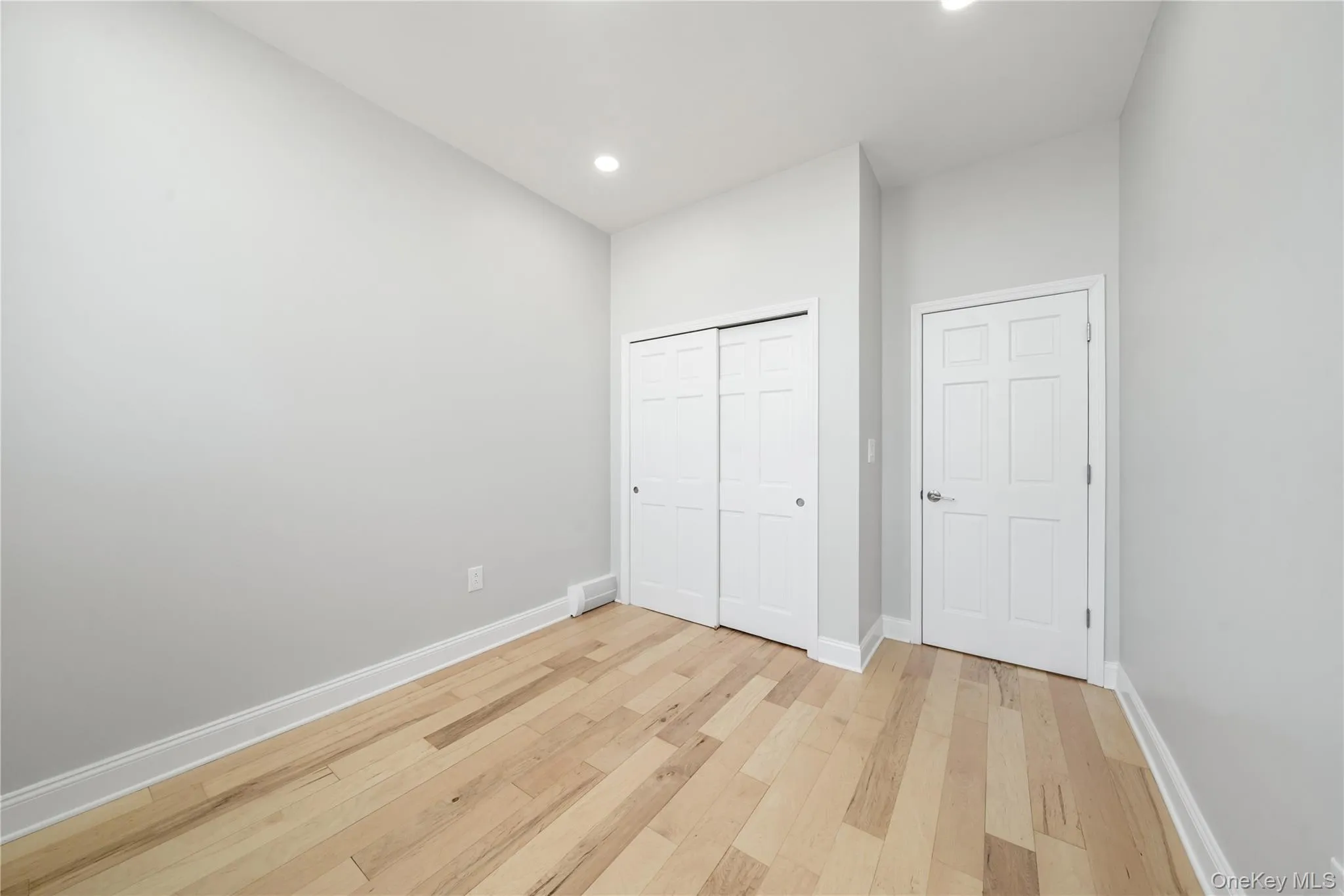 Light-colored wood-finish flooring complements the neutral wall color and white trim Light-colored wood-finish flooring complements the neutral wall color and white trim
