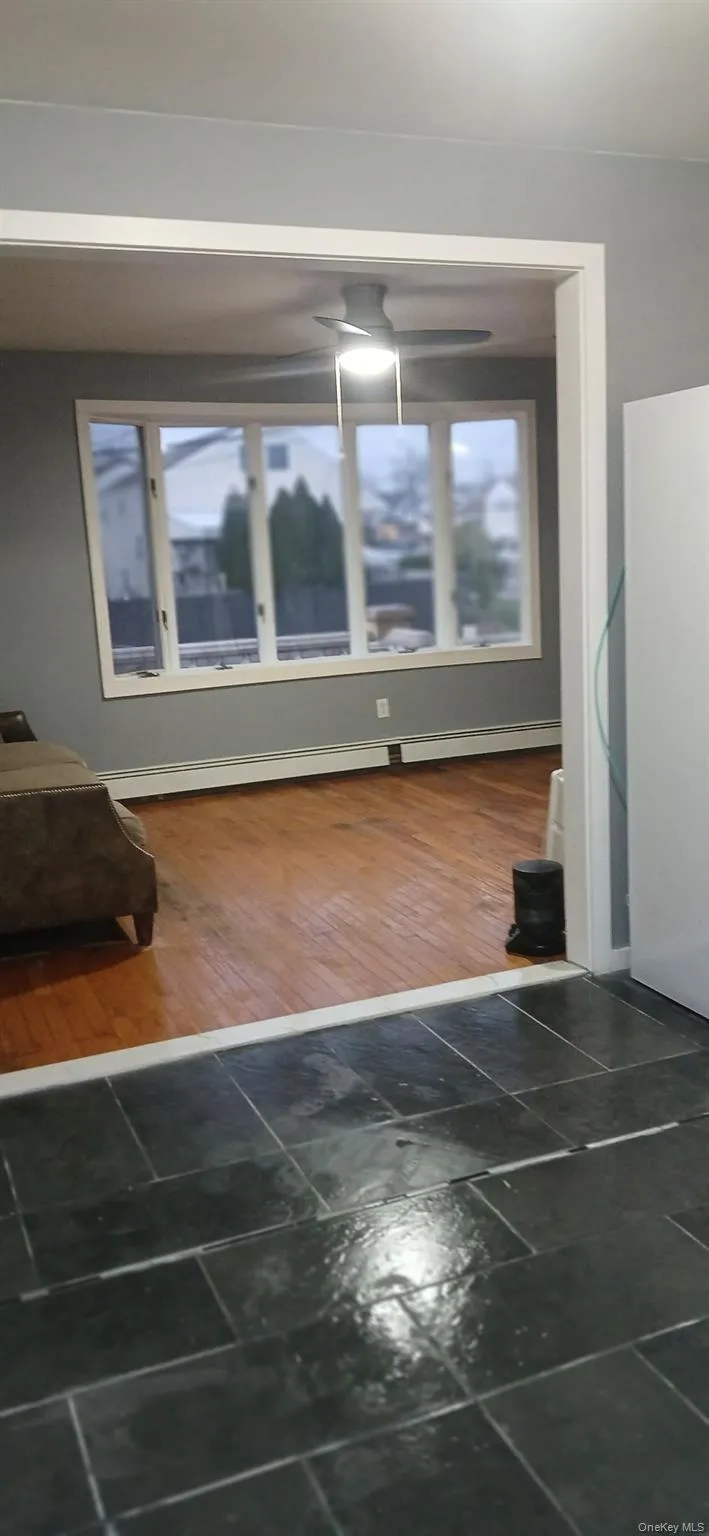 Detailed view of baseboard heating and wood finished floors Detailed view of baseboard heating and wood finished floors
