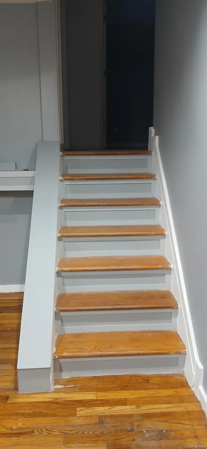 Staircase featuring wood-type flooring Staircase featuring wood-type flooring
