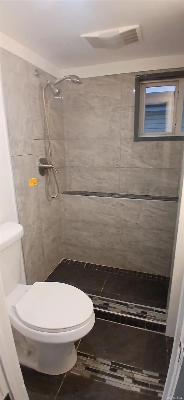 Full bathroom featuring a stall shower and tile patterned floors Full bathroom featuring a stall shower and tile patterned floors