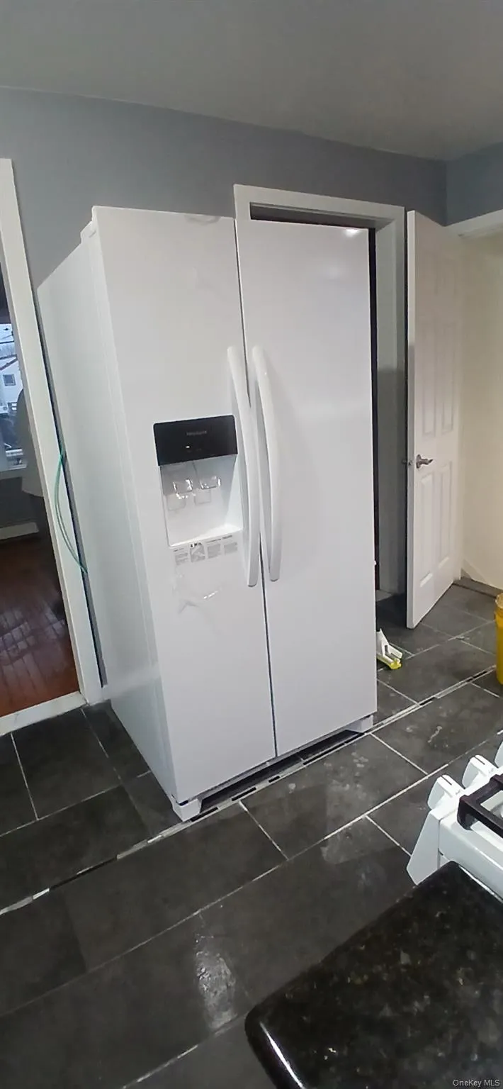 Kitchen view of white fridge with ice dispenser Kitchen view of white fridge with ice dispenser