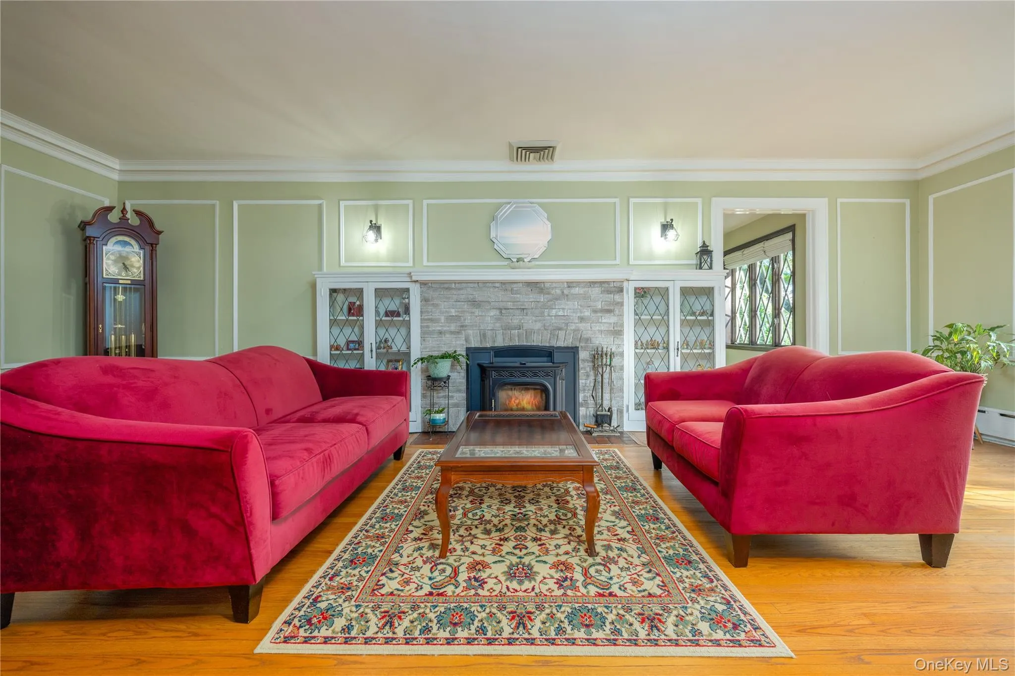 Formal living room with custom built-ins surrounding the fireplace, currently keeping your heating bills low with a pellet fireplace Formal living room with custom built-ins surrounding the fireplace, currently keeping your heating bills low with a pellet fireplace