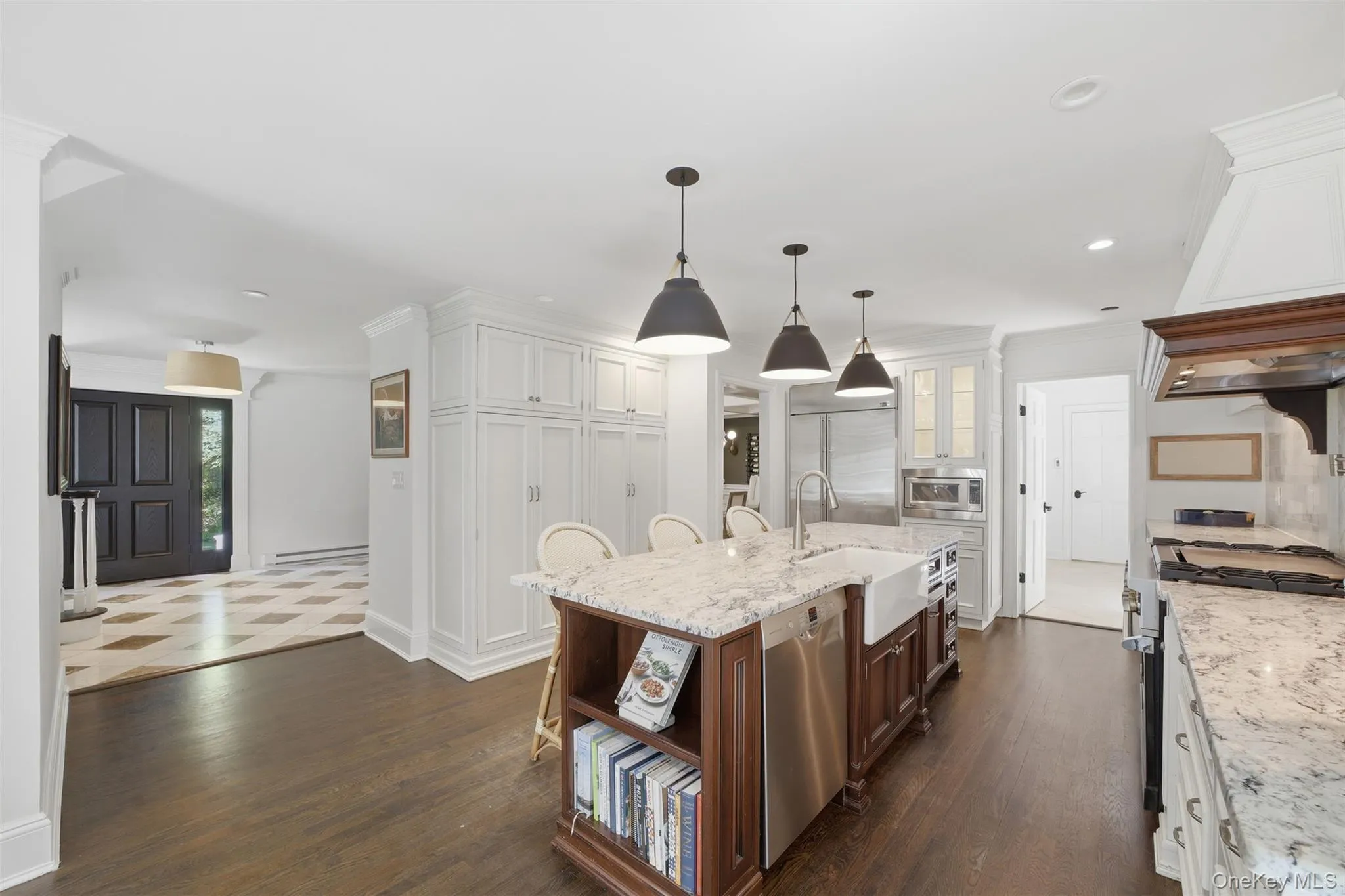 Hardwood floors, generous island, plenty of cabinets, beautiful stone backsplash Hardwood floors, generous island, plenty of cabinets, beautiful stone backsplash