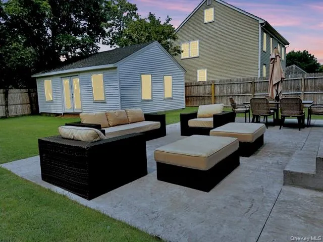 Fenced backyard with a patio area, an outdoor living space, and french doors Fenced backyard with a patio area, an outdoor living space, and french doors