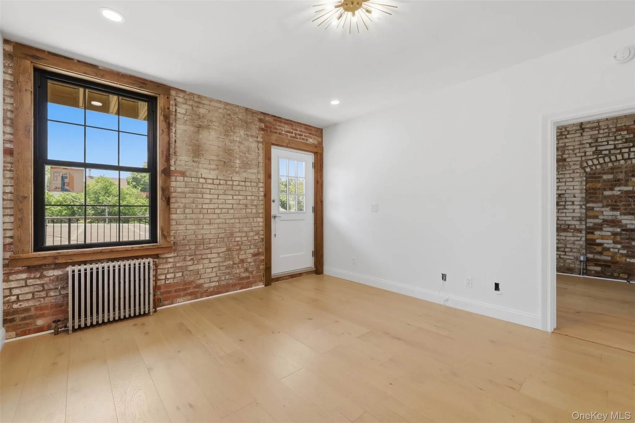 Exposed Brick in the Oversized Living Room with access to Back Deck Exposed Brick in the Oversized Living Room with access to Back Deck