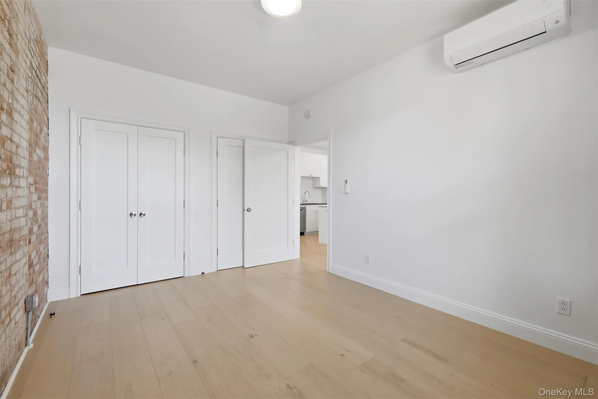 Spacious Bedroom with Exposed Brick and 2 Double Closets Spacious Bedroom with Exposed Brick and 2 Double Closets