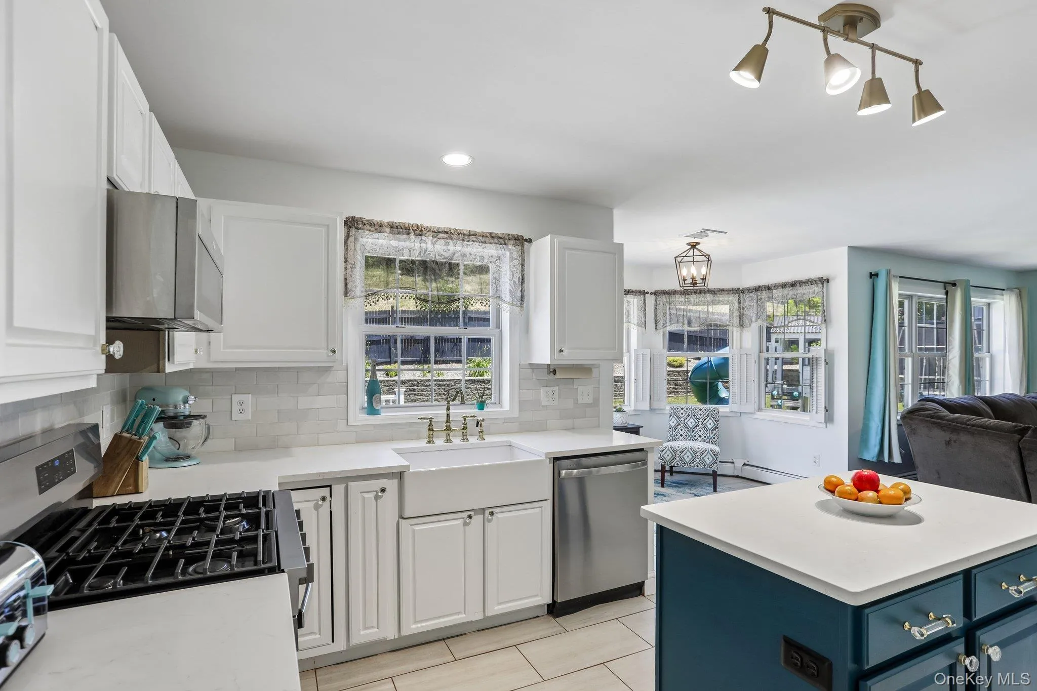Large kitchen with tiled backsplash, pantry, stainless steel appliances and quartz countertops. Large kitchen with tiled backsplash, pantry, stainless steel appliances and quartz countertops.