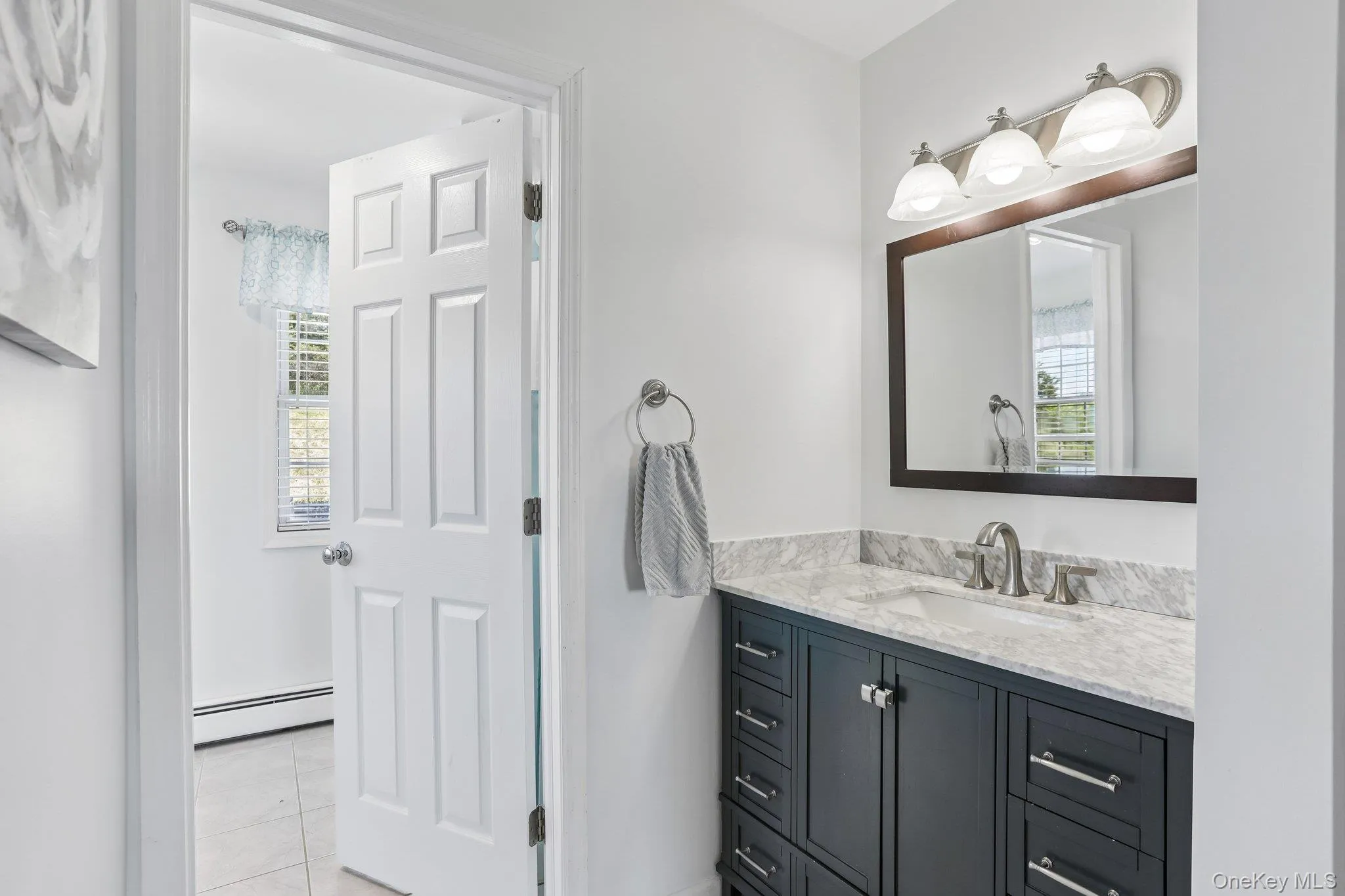 Private primary bathroom with quartz countertop. Private primary bathroom with quartz countertop.
