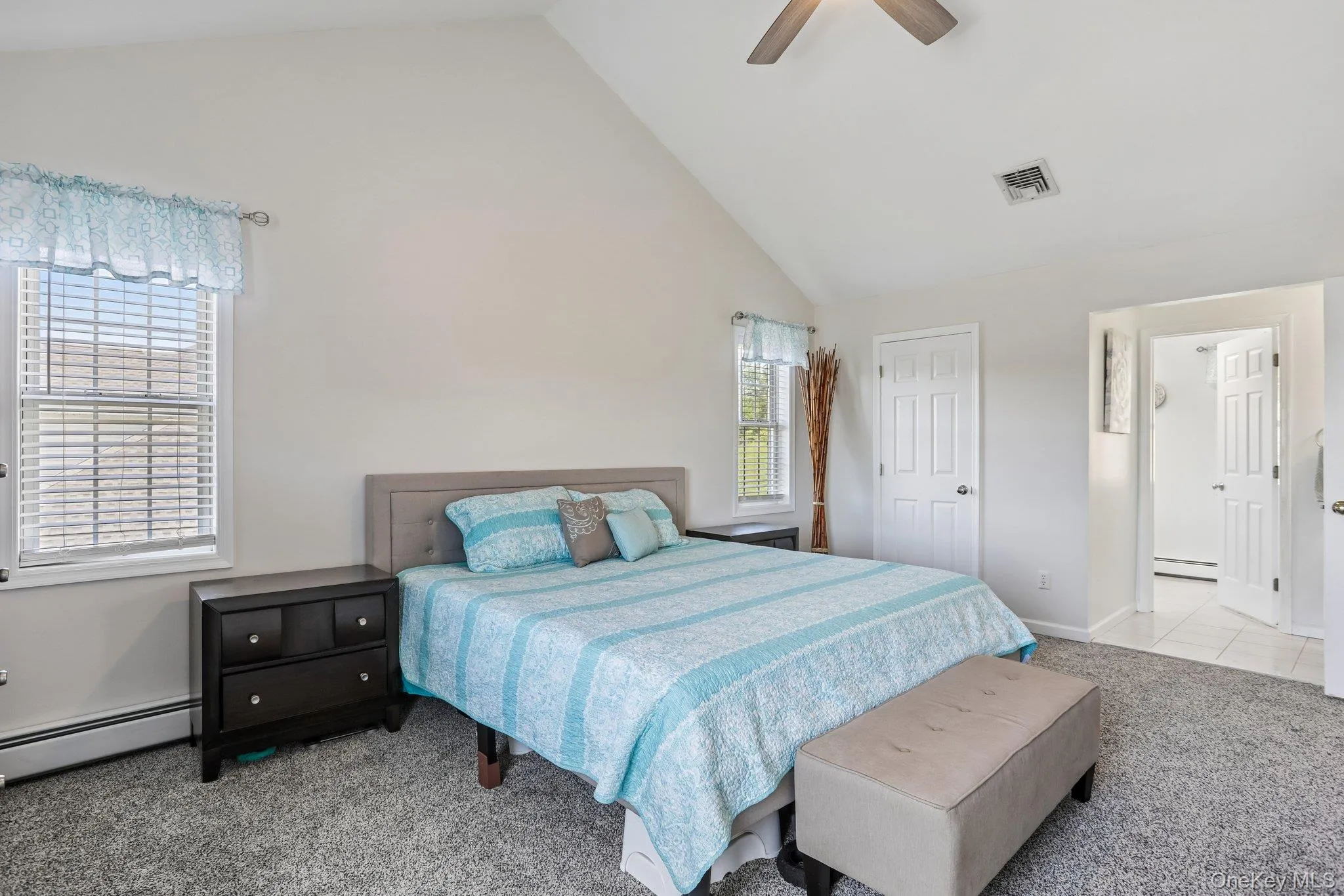 Primary bedroom carpeted flooring and cathedral ceiling. Primary bedroom carpeted flooring and cathedral ceiling.