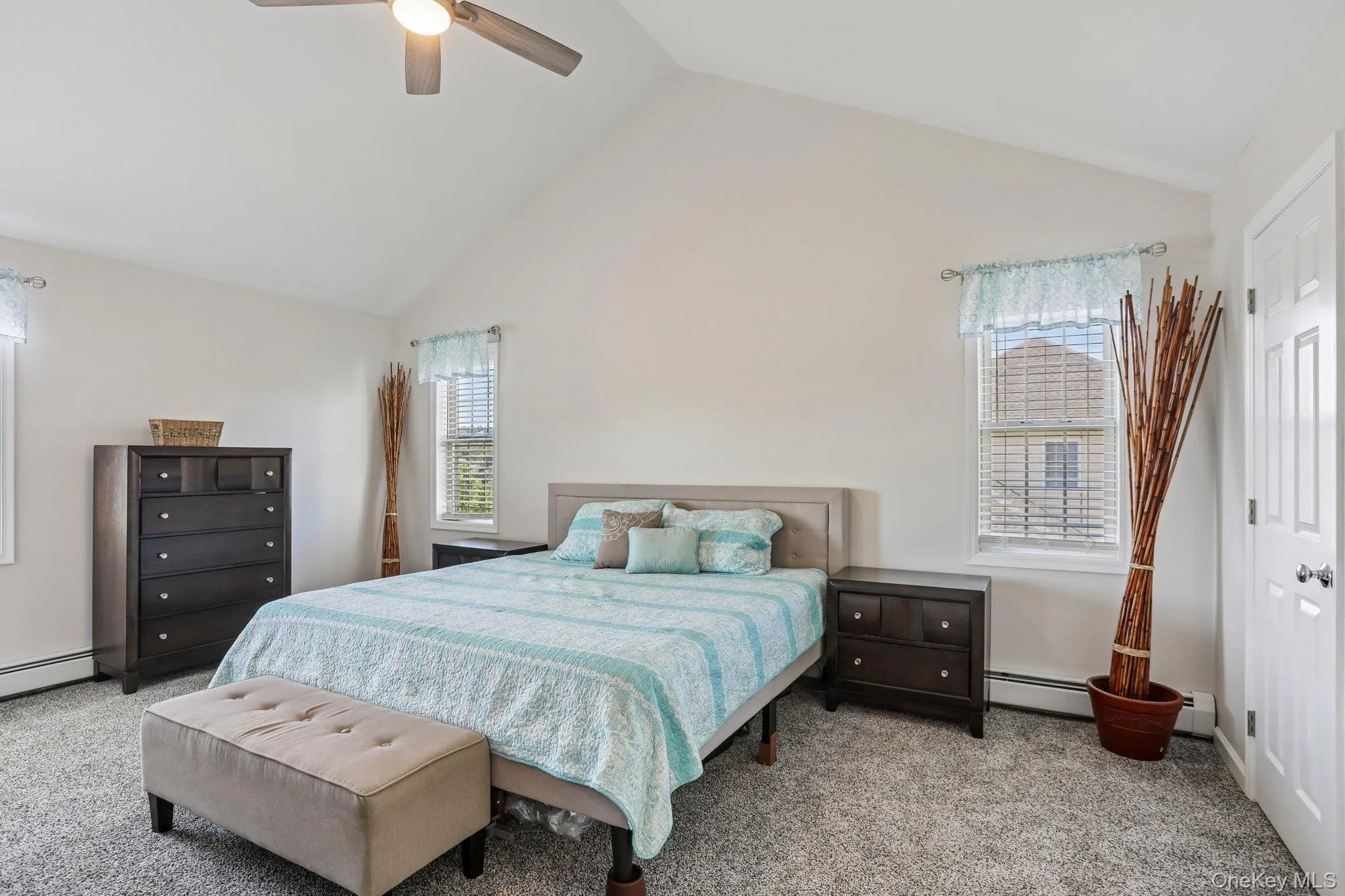 Primary bedroom with cathedral ceiling. Primary bedroom with cathedral ceiling.