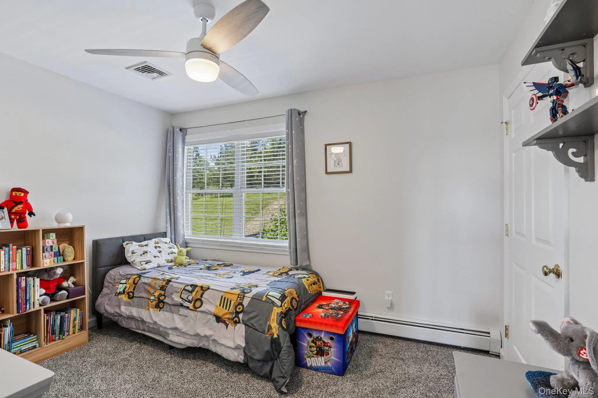 Bedroom with carpeting and ceiling fam. Bedroom with carpeting and ceiling fam.