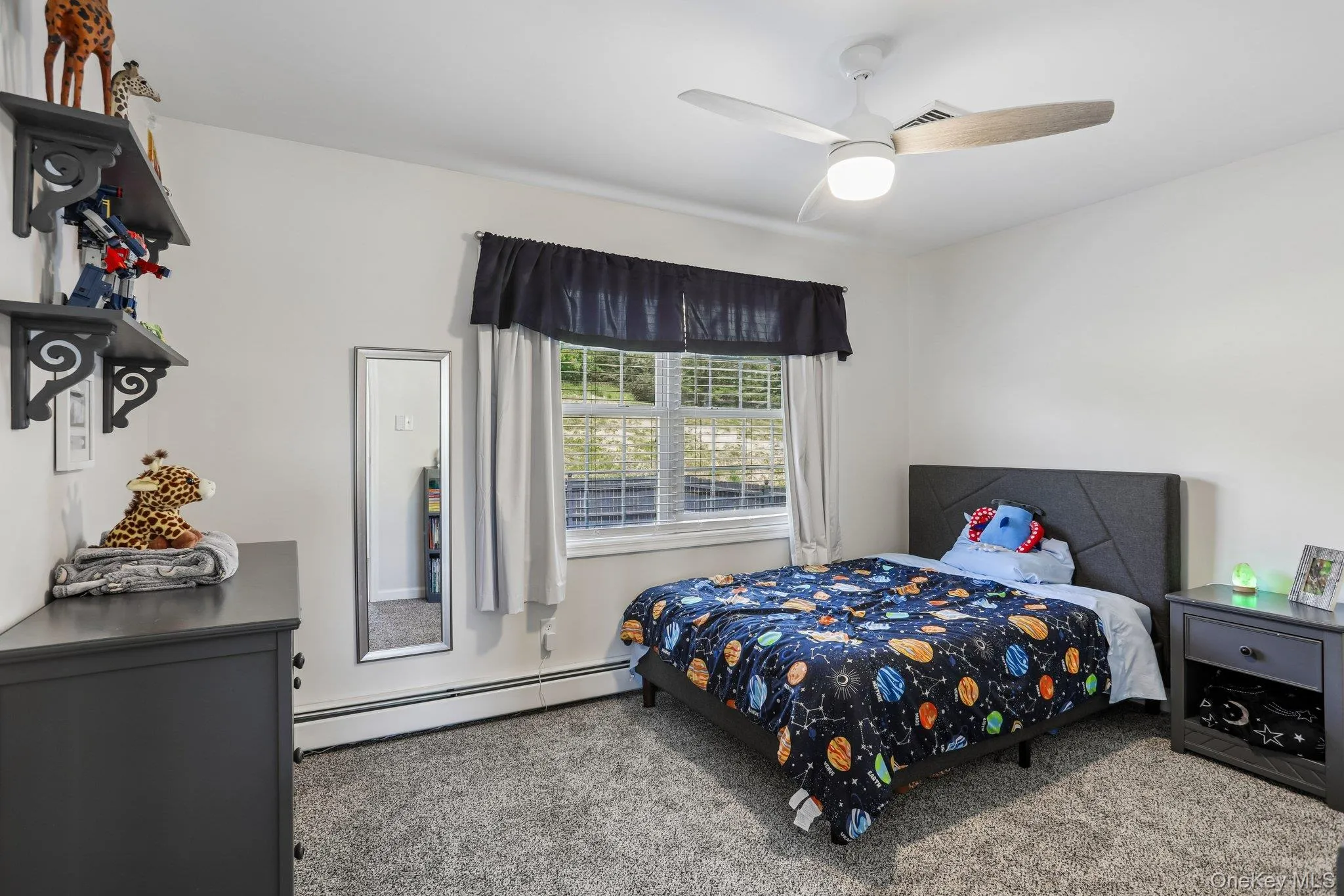 Carpeted bedroom with plenty of closet space. Carpeted bedroom with plenty of closet space.
