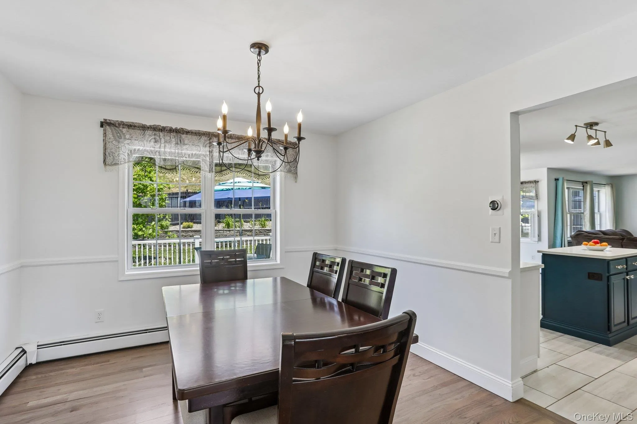 Formal dining room with hardwood floors and chair rail. Formal dining room with hardwood floors and chair rail.