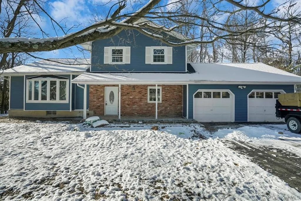 View of front facade with an attached garage and brick siding View of front facade with an attached garage and brick siding