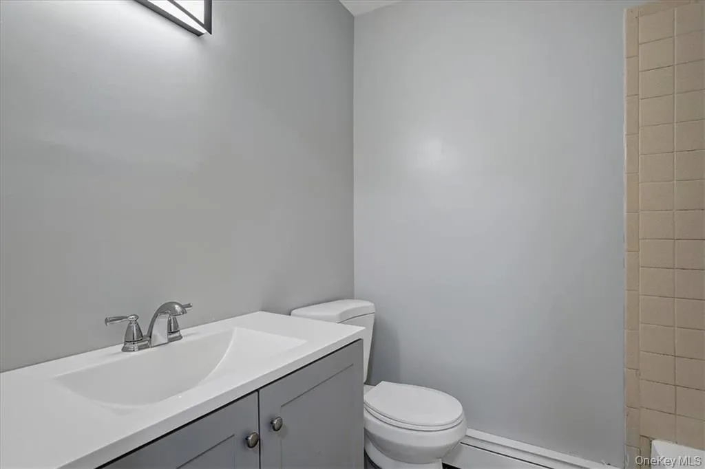 Bathroom featuring vanity, a bathtub, and a shower Bathroom featuring vanity, a bathtub, and a shower