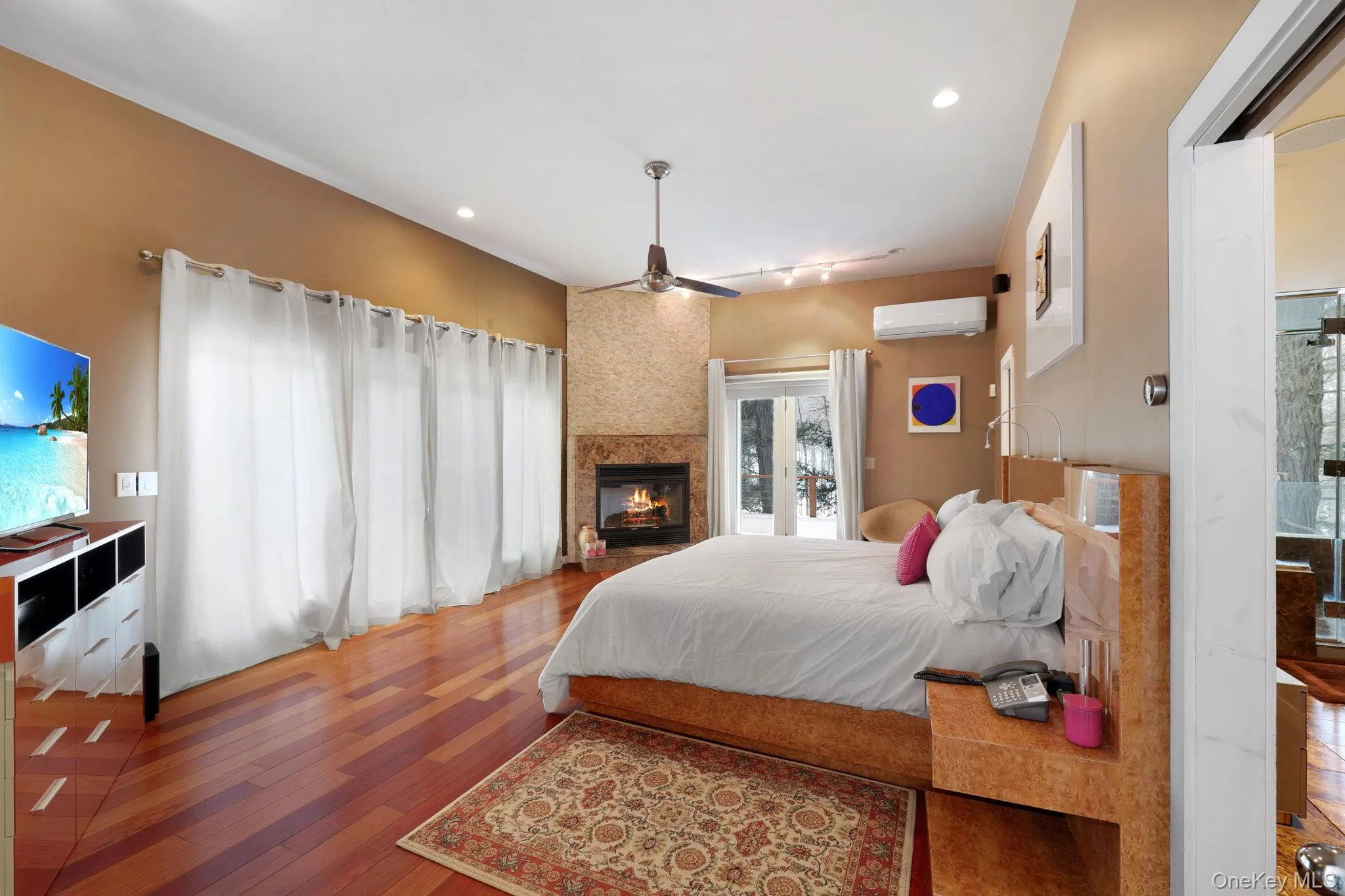 Primary bedroom featuring a fireplace connected to Primary bathroom with walk in closet, sitting room suite Primary bedroom featuring a fireplace connected to Primary bathroom with walk in closet, sitting room suite