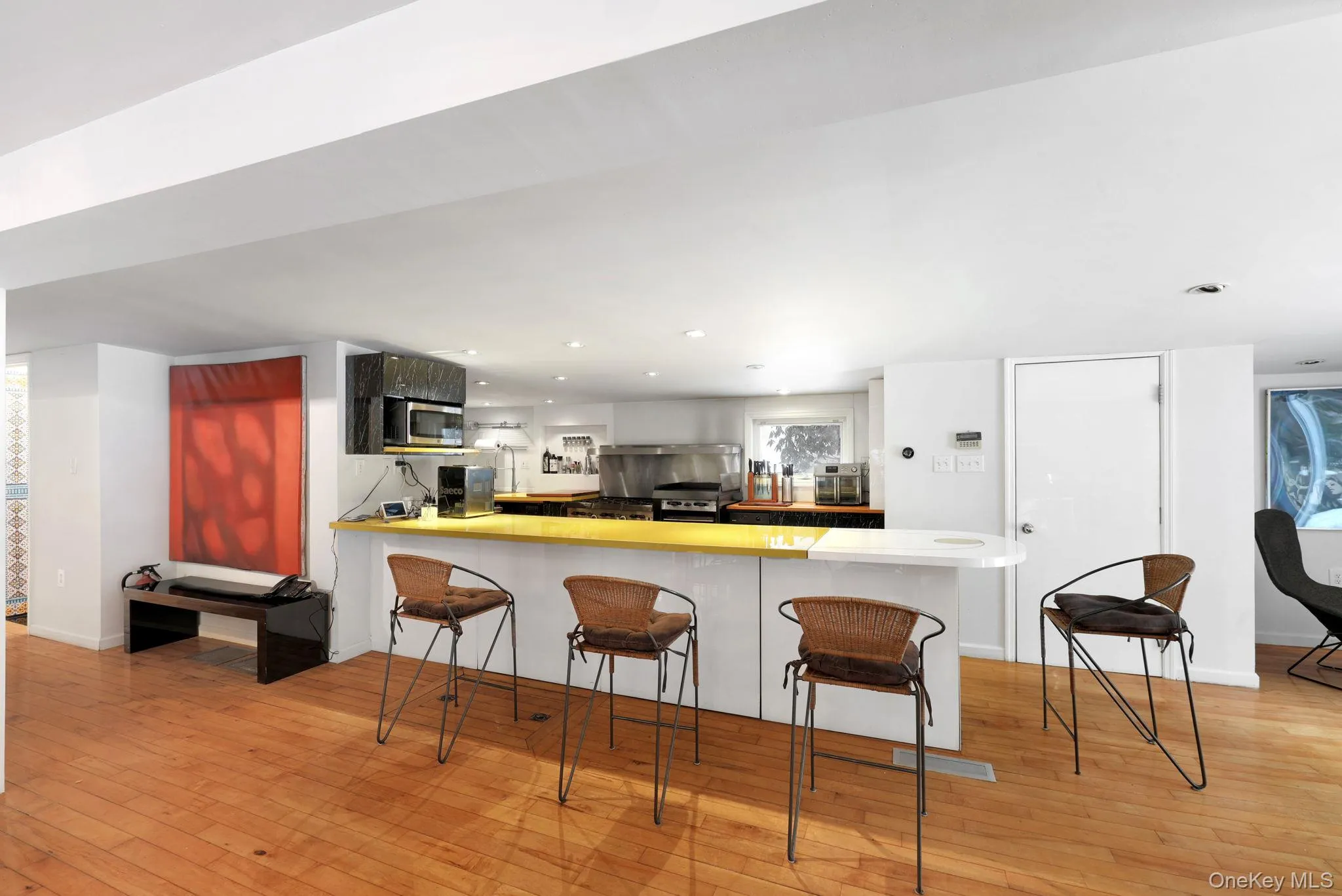 Kitchen featuring a trash compactor, updated appliances, and commerical stove Kitchen featuring a trash compactor, updated appliances, and commerical stove