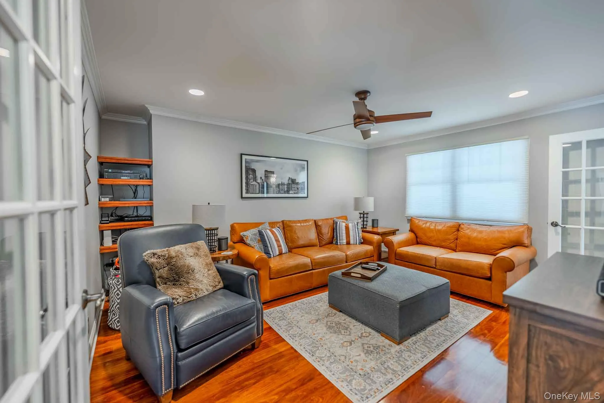 Bright, spacious living room with stunning hardwood floors, recessed lighting, and elegant French doors. Bright, spacious living room with stunning hardwood floors, recessed lighting, and elegant French doors.