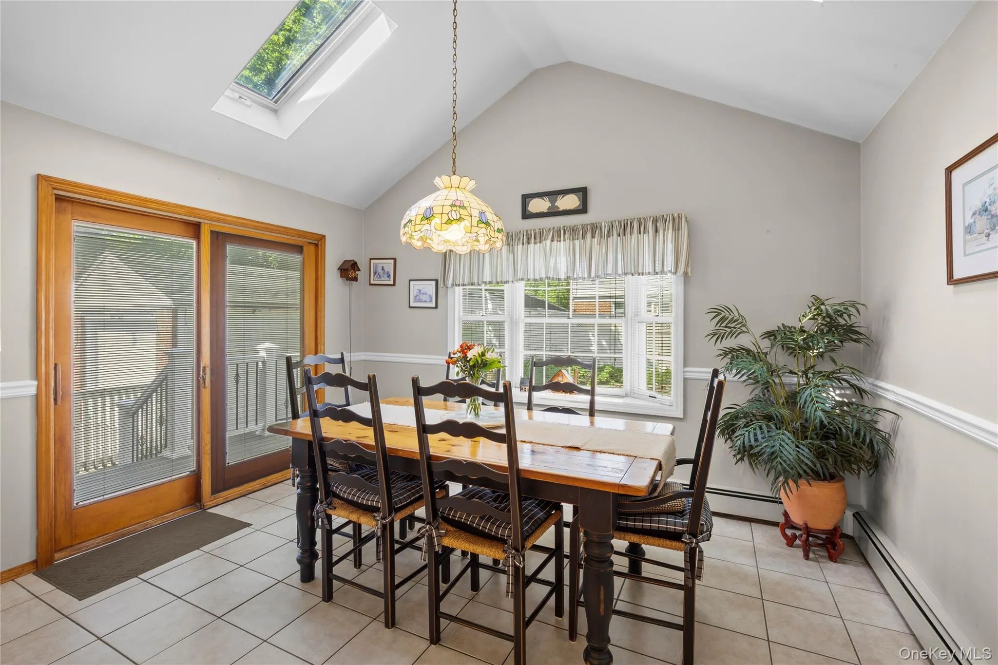 Main Floor Extension- Dining Area w/vaulted ceiling. Pella sliding door to the Trex Deck, patio and fully fenced yard beyond. Main Floor Extension- Dining Area w/vaulted ceiling. Pella sliding door to the Trex Deck, patio and fully fenced yard beyond.