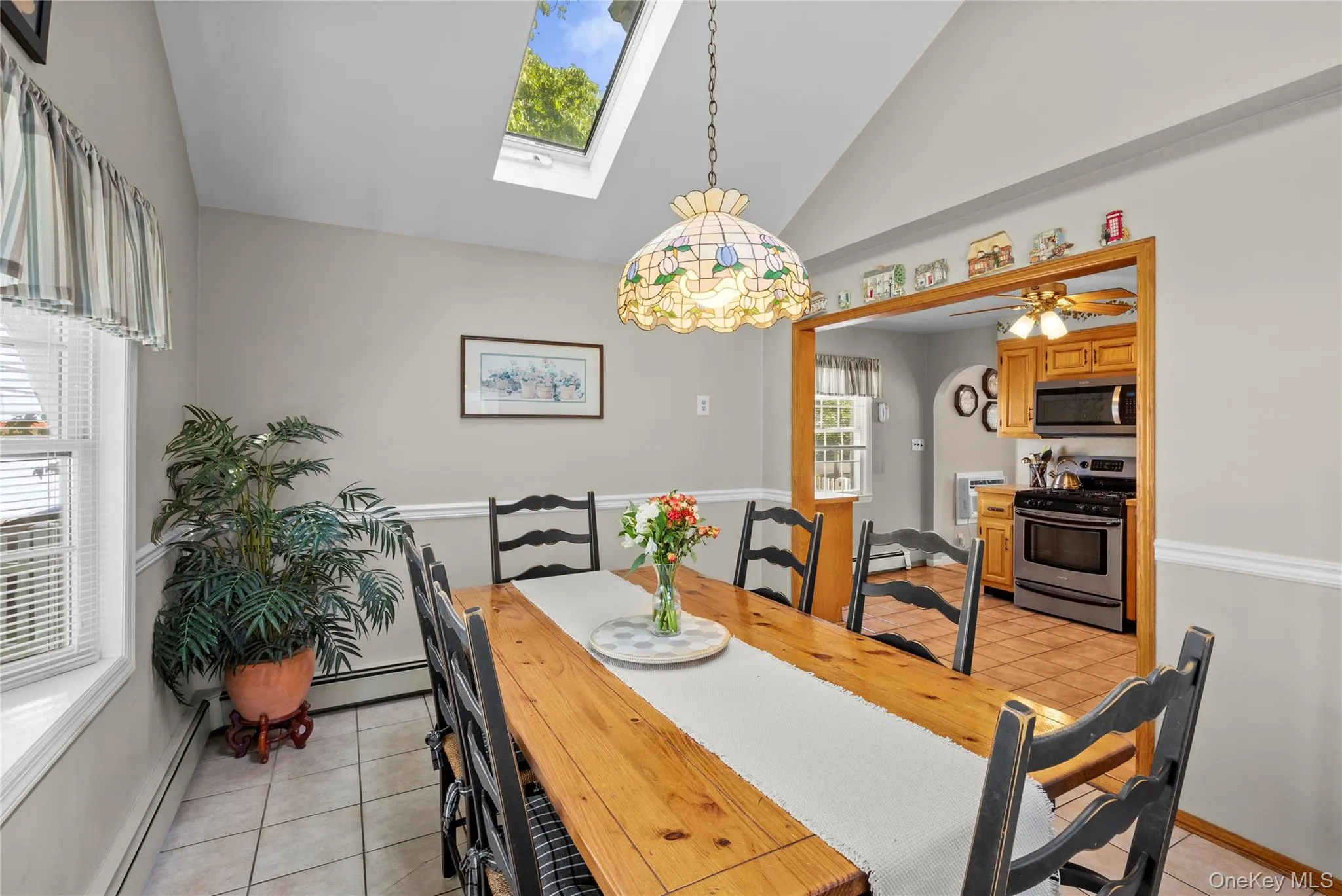 Dining area open to kitchen space with vaulted ceiling Dining area open to kitchen space with vaulted ceiling