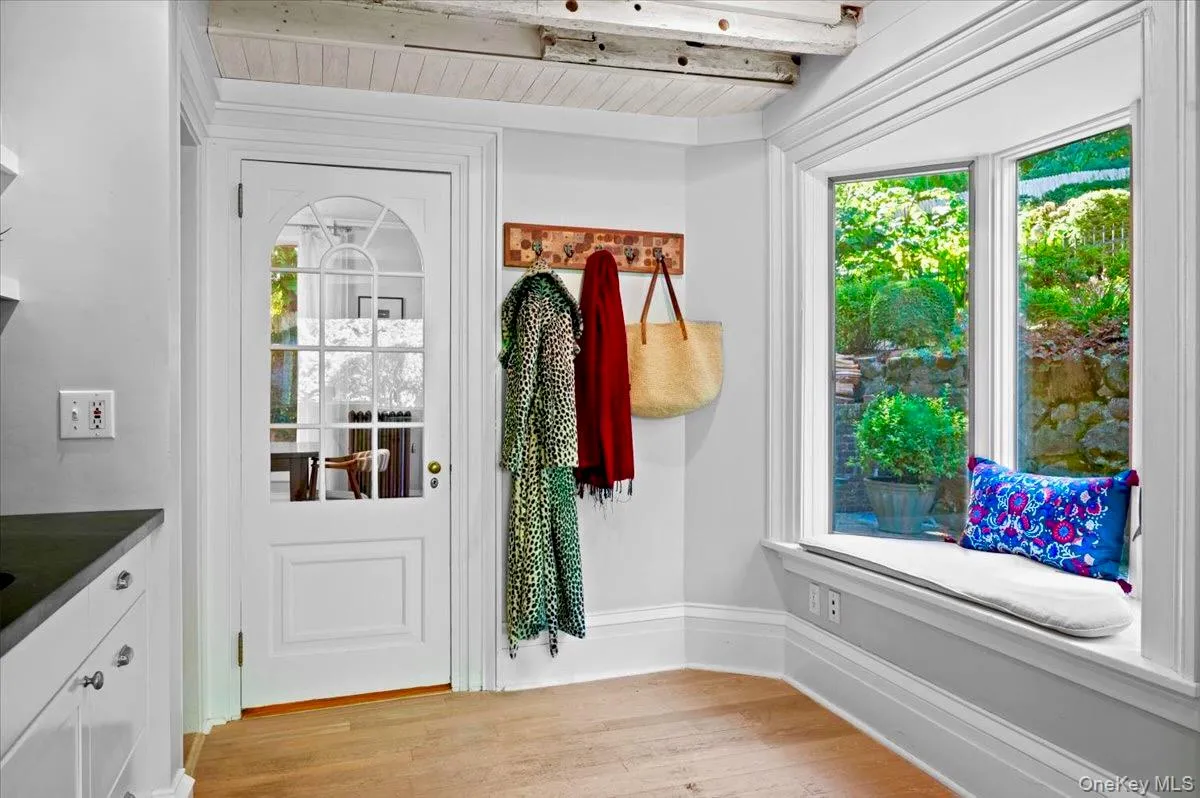 Doorway to outside with wood finished floors and a wood ceiling with exposed beams Doorway to outside with wood finished floors and a wood ceiling with exposed beams