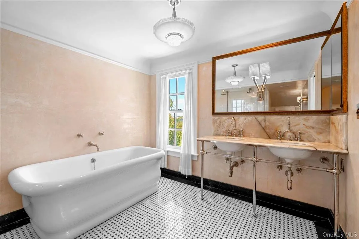 Full bathroom featuring a freestanding tub and dual sinks Full bathroom featuring a freestanding tub and dual sinks