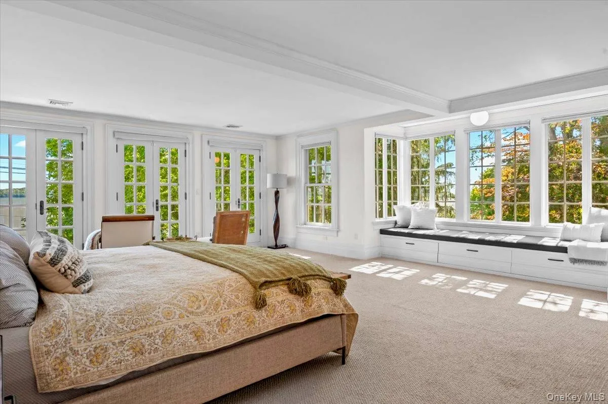 Bedroom featuring carpet, crown molding, access to exterior, french doors, and beamed ceiling Bedroom featuring carpet, crown molding, access to exterior, french doors, and beamed ceiling