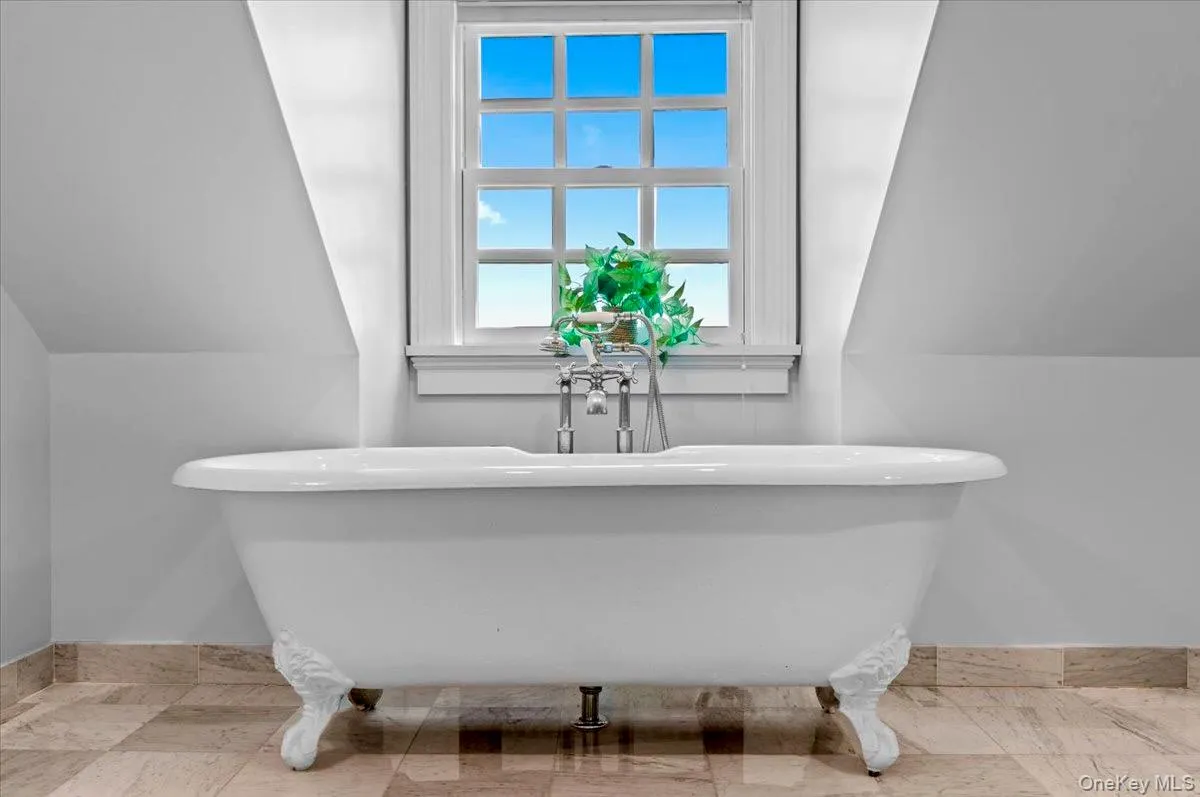 Full bathroom with vaulted ceiling and a freestanding tub Full bathroom with vaulted ceiling and a freestanding tub