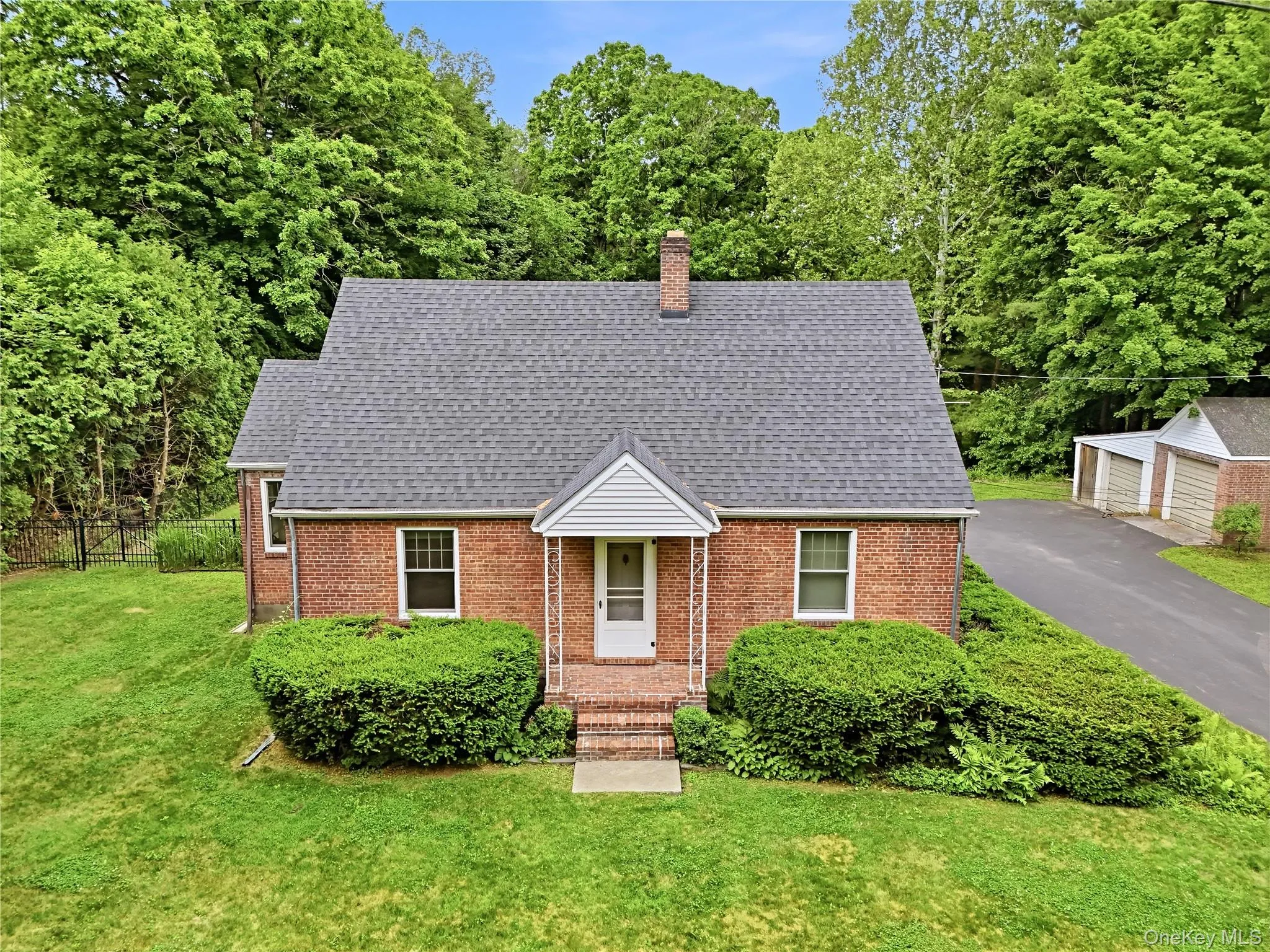 Red brick cape cod with 2 car detached garage Red brick cape cod with 2 car detached garage