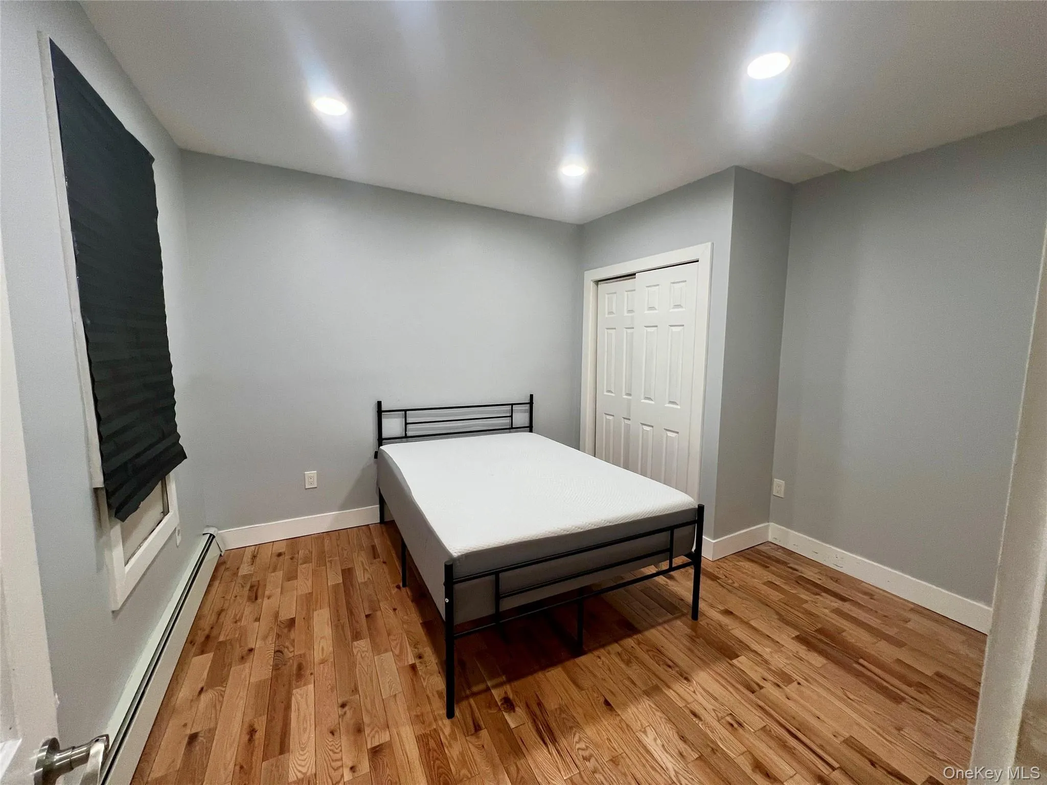 Bedroom featuring woodfloors, a closet, and recessed lighting Bedroom featuring woodfloors, a closet, and recessed lighting
