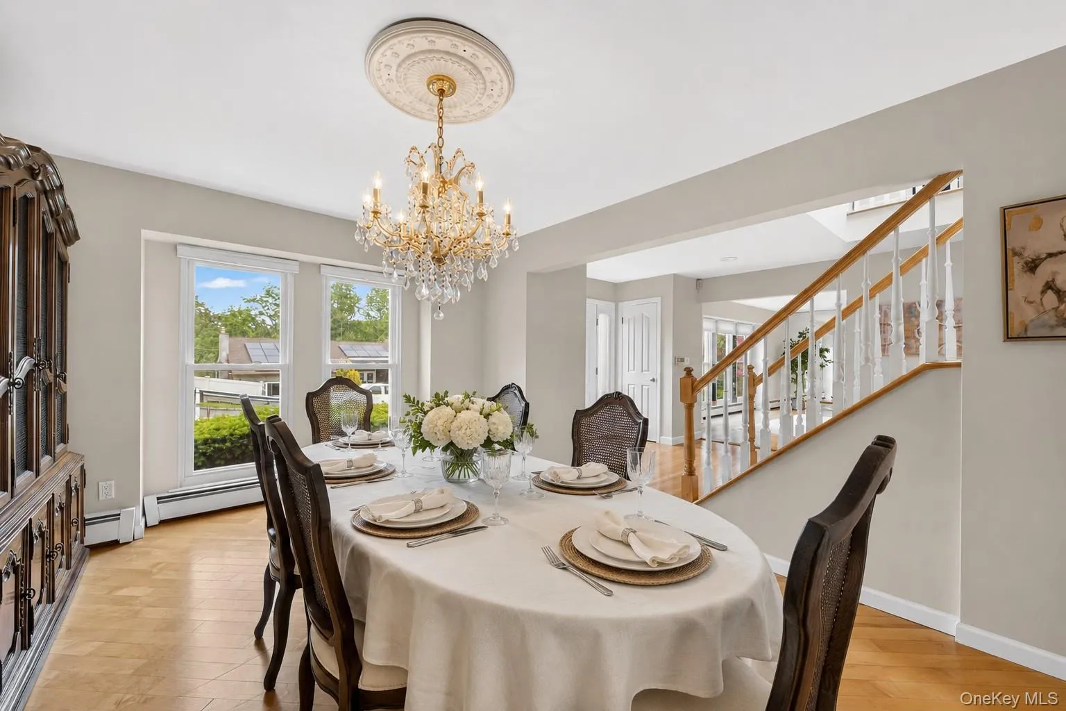 Formal dining room with chandelier and oversized windows. Formal dining room with chandelier and oversized windows.