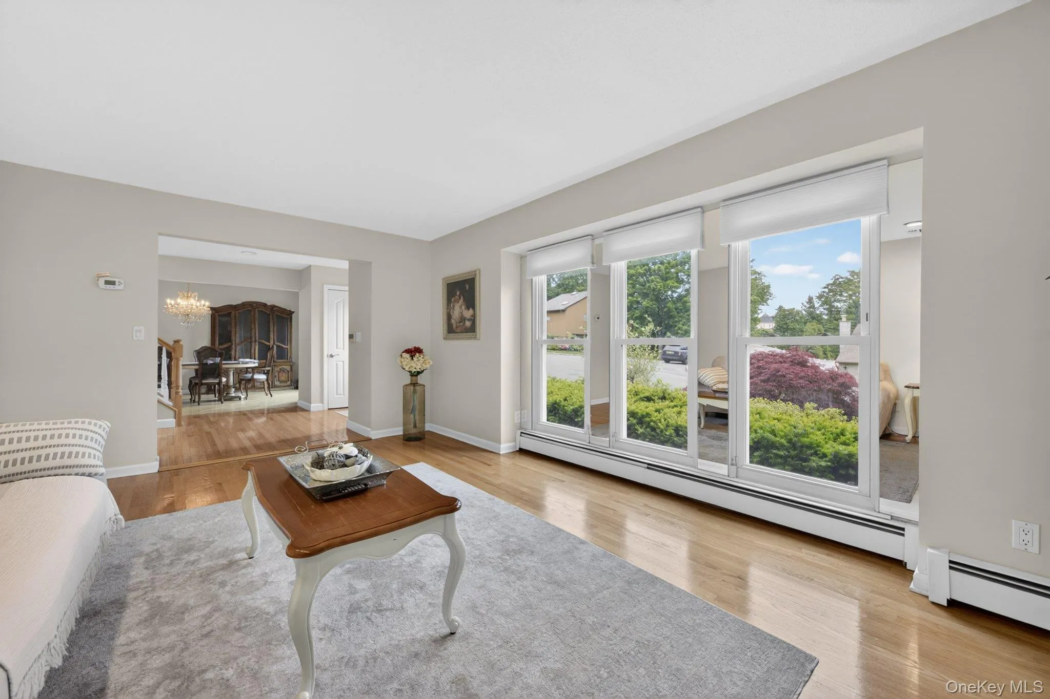 Living room with abundance of sunlight through wall of windows. Living room with abundance of sunlight through wall of windows.