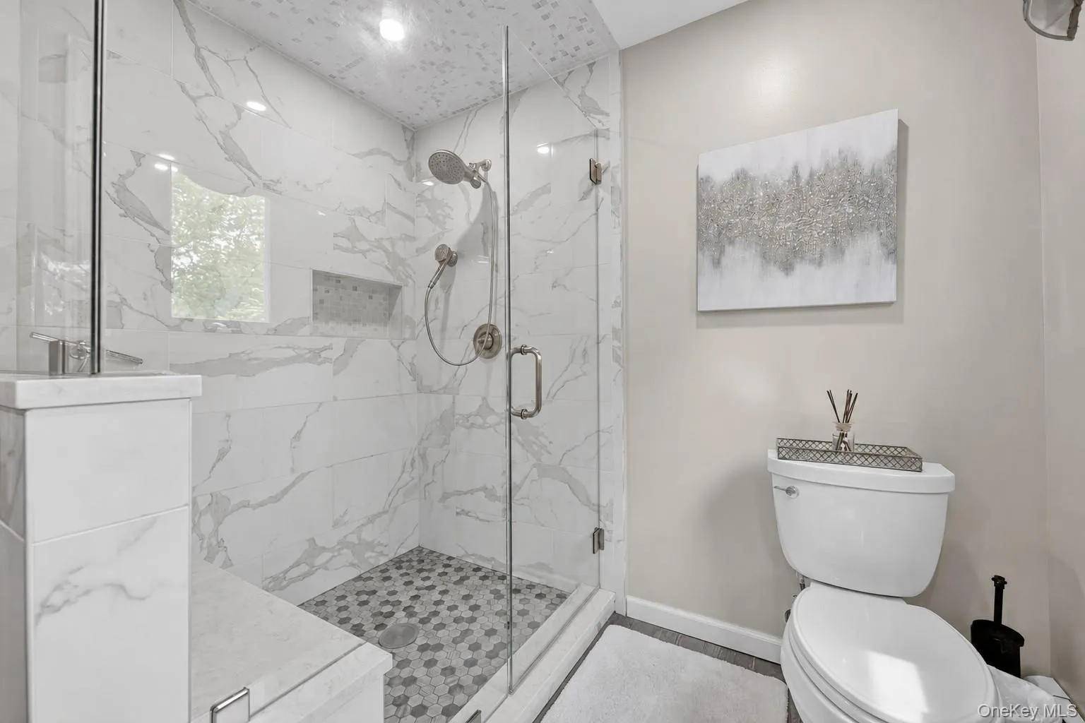 Oversized glass enclosed shower with seating. Oversized glass enclosed shower with seating.