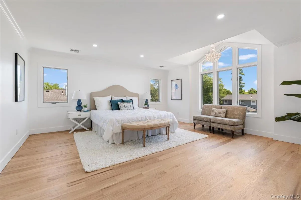 Bedroom featuring light wood-style floors, a chandelier, and recessed lighting Bedroom featuring light wood-style floors, a chandelier, and recessed lighting