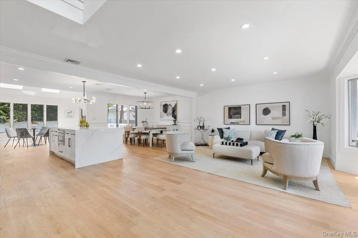 Living area featuring ornamental molding, a chandelier, light wood-style flooring, and recessed lighting Living area featuring ornamental molding, a chandelier, light wood-style flooring, and recessed lighting