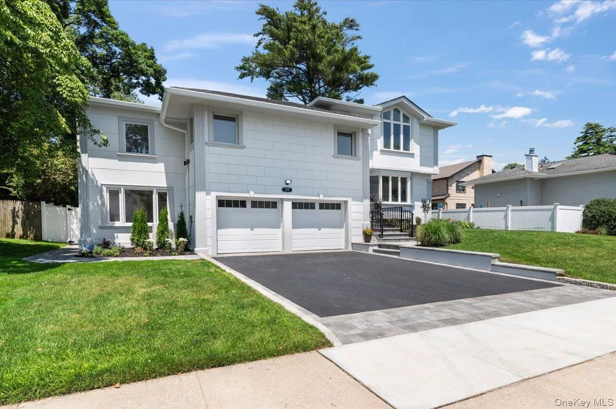 Modern home with asphalt driveway and a garage Modern home with asphalt driveway and a garage