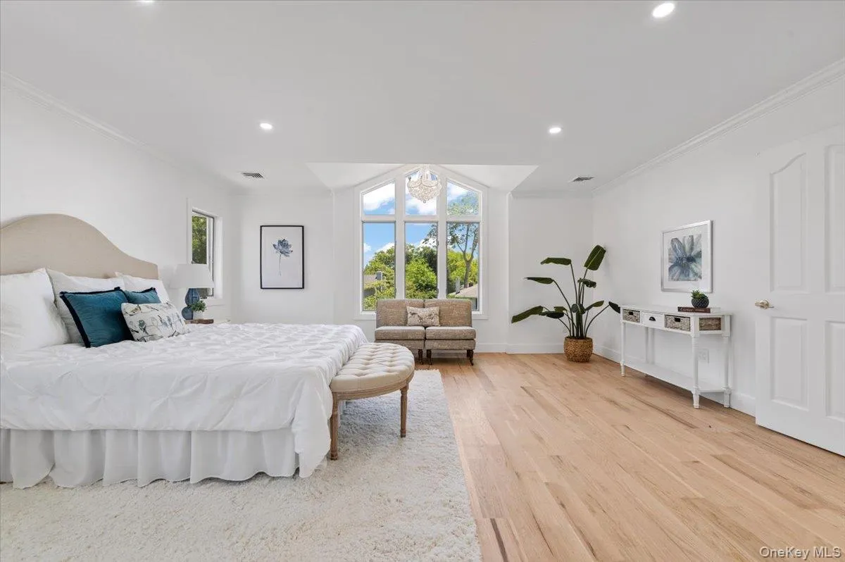 Bedroom featuring light wood finished floors, crown molding, and recessed lighting Bedroom featuring light wood finished floors, crown molding, and recessed lighting