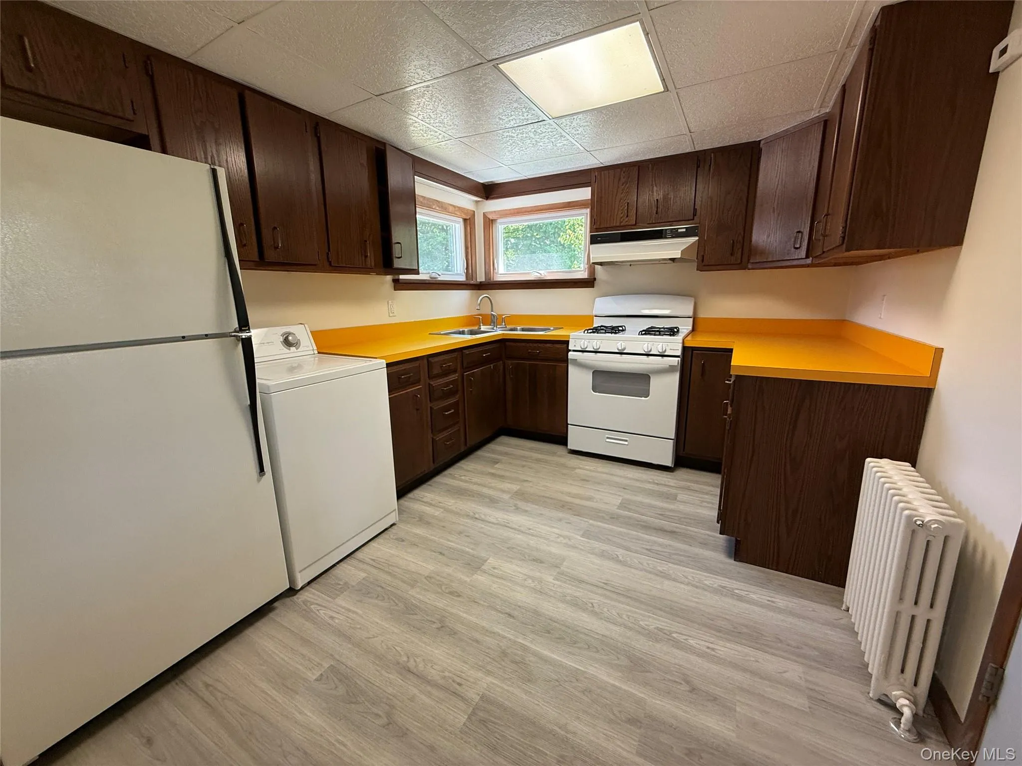 Kitchen with brand new laminate flooring and offers a double sink Kitchen with brand new laminate flooring and offers a double sink