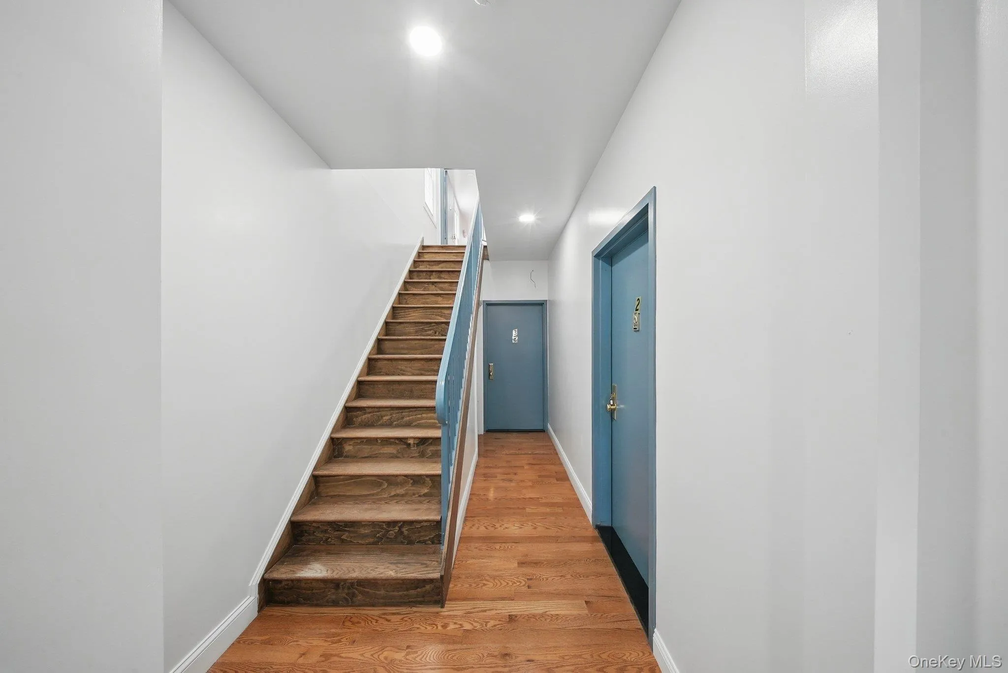 Stairway featuring recessed lighting, baseboards, and wood finished floors Stairway featuring recessed lighting, baseboards, and wood finished floors