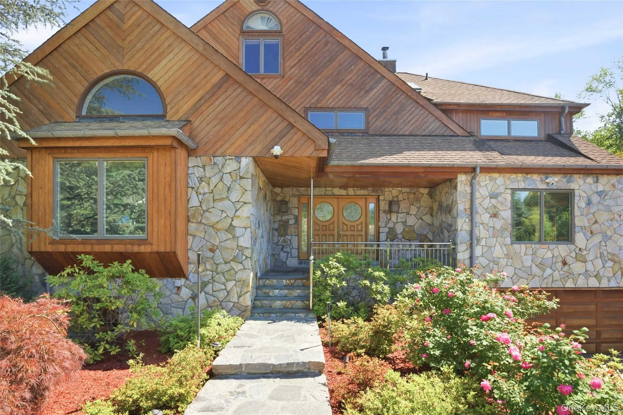 Distinctive Curb Appeal: Striking architecture, stone accents, and mature landscaping create an unforgettable first impression. Distinctive Curb Appeal: Striking architecture, stone accents, and mature landscaping create an unforgettable first impression.