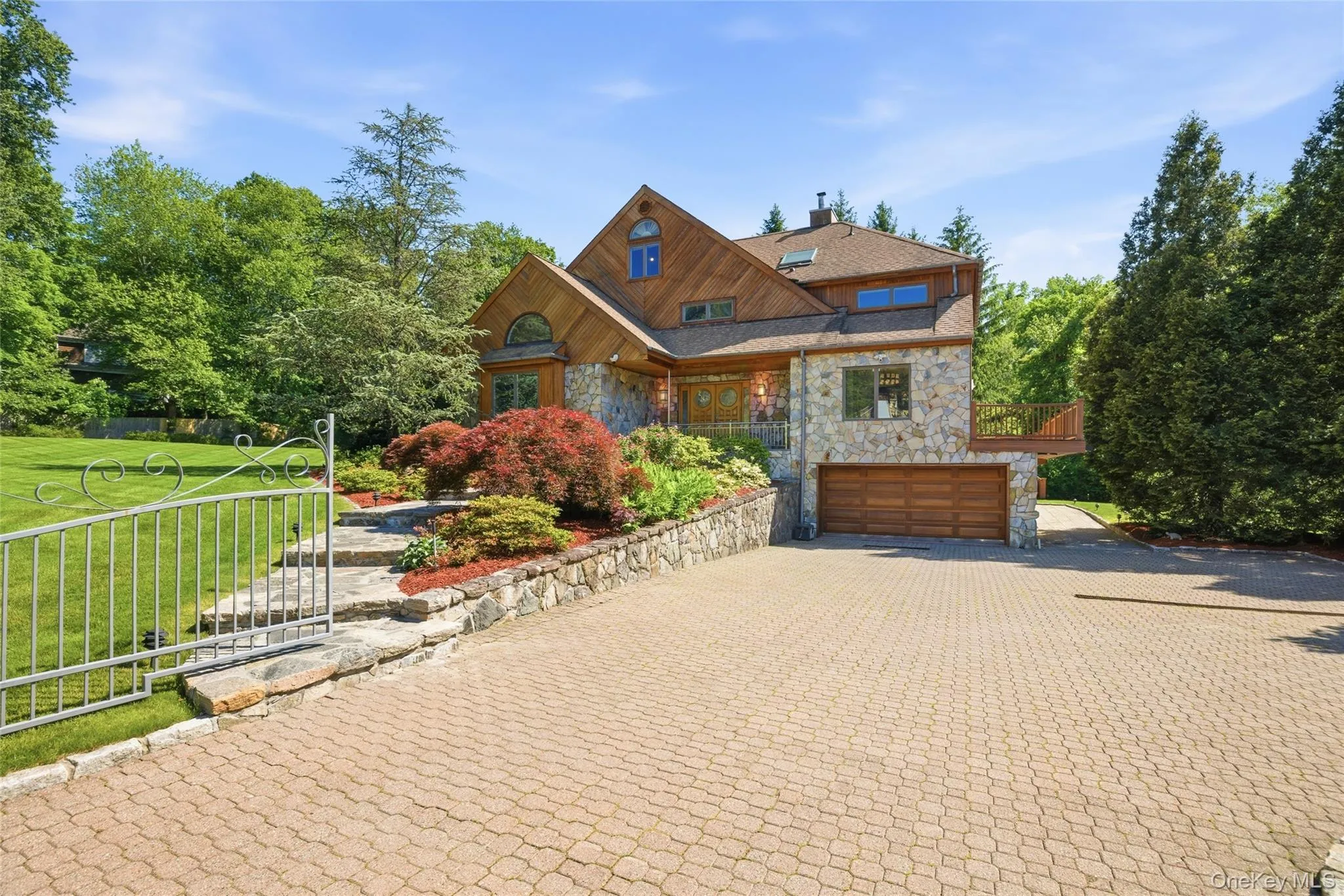 Private Estate Entrance: A spacious paver driveway provides ample parking while enhancing the home's impressive presence. Private Estate Entrance: A spacious paver driveway provides ample parking while enhancing the home's impressive presence.