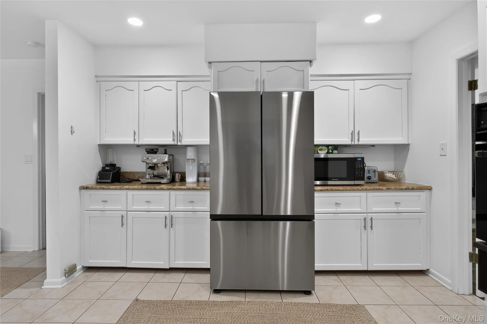 Kitchen has white cabinetry with brushed nickel hardware and loads of cabinet space. Kitchen has white cabinetry with brushed nickel hardware and loads of cabinet space.