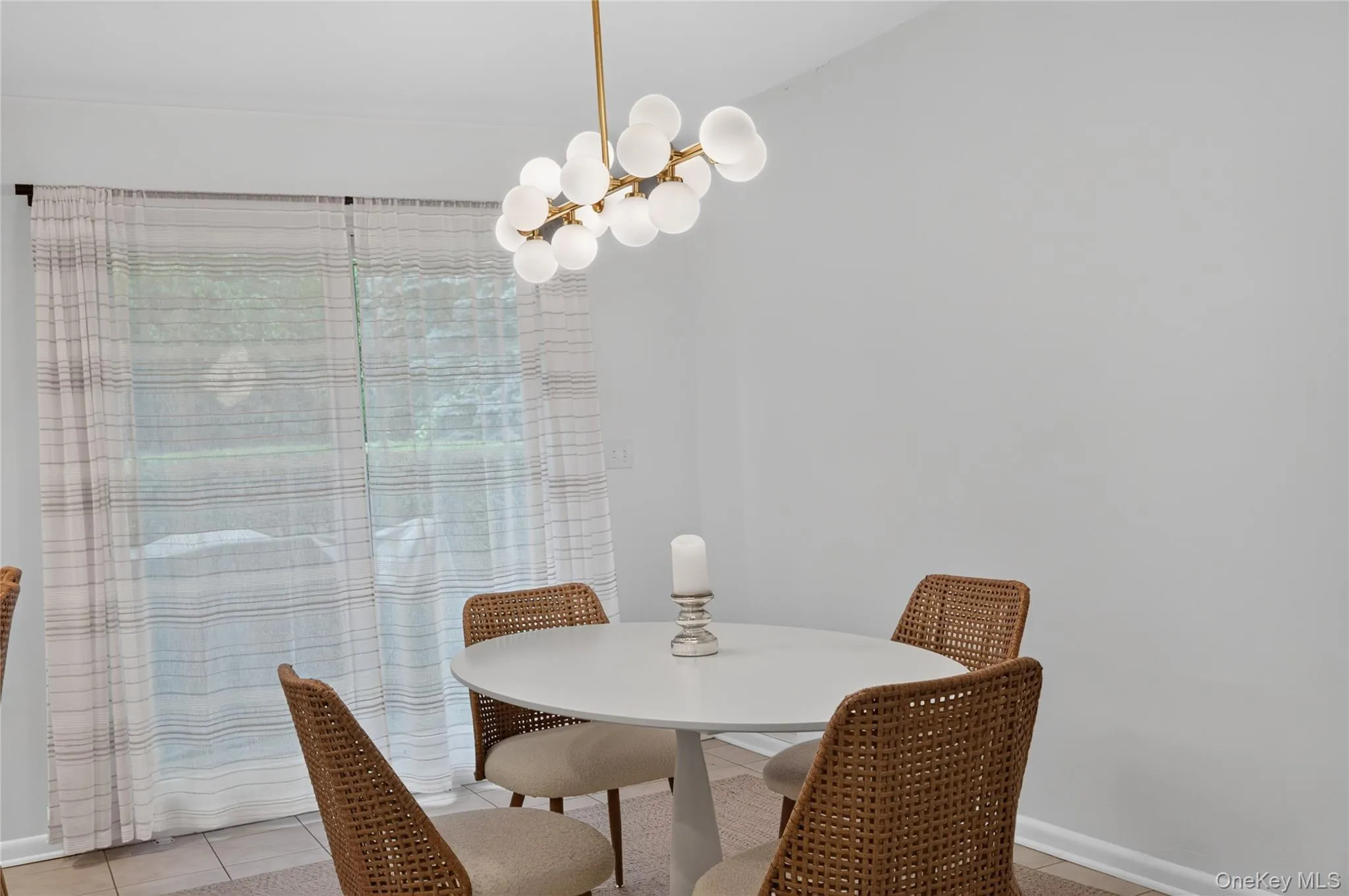 Eat in Kitchen featuring a modern brass chandelier, and additional access to the rear patio. Eat in Kitchen featuring a modern brass chandelier, and additional access to the rear patio.