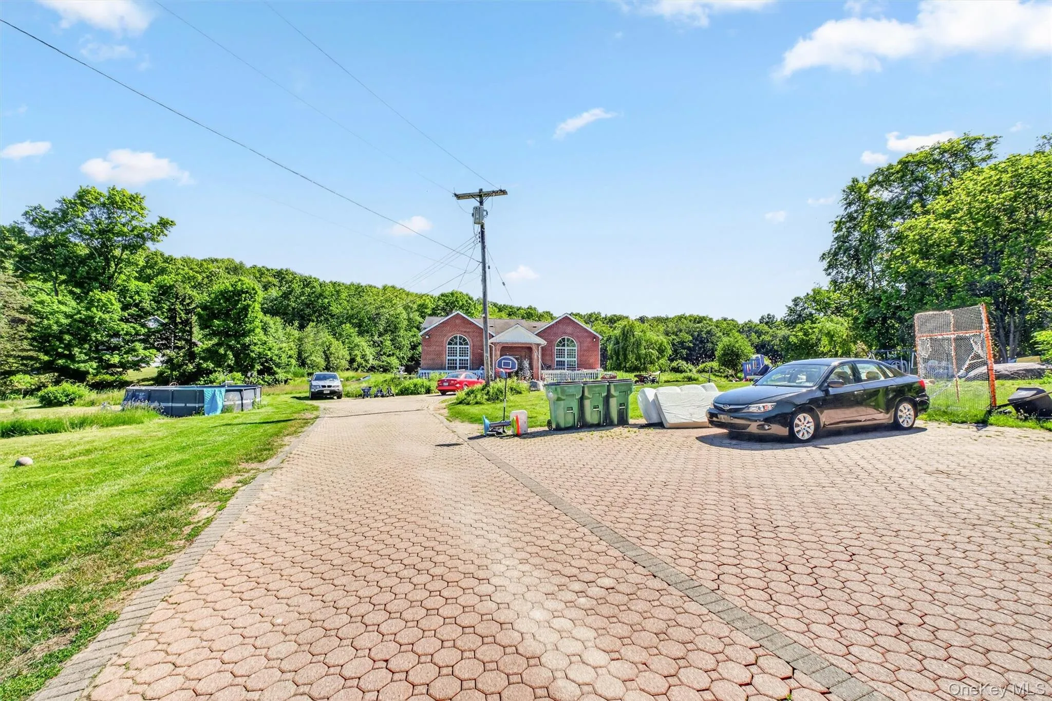 The expansive parking area in front of the home offers ample space for multiple vehicles and a variety of additional uses. The expansive parking area in front of the home offers ample space for multiple vehicles and a variety of additional uses.