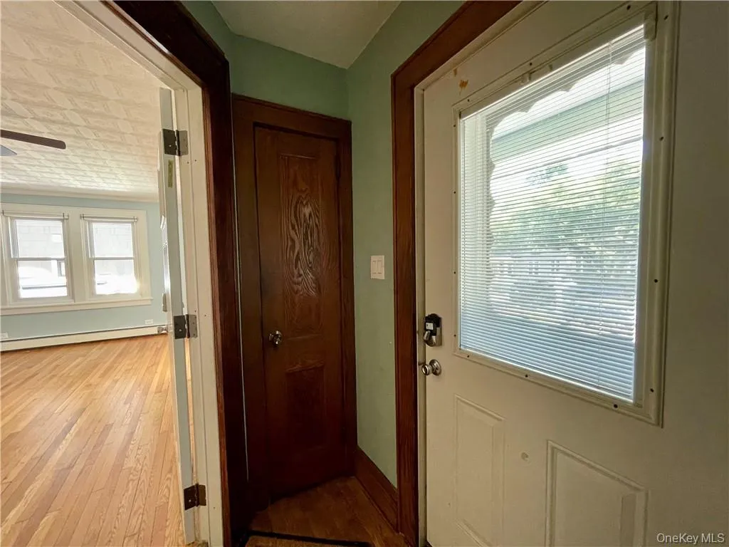 Front entry from porch with a foyer and closet Front entry from porch with a foyer and closet