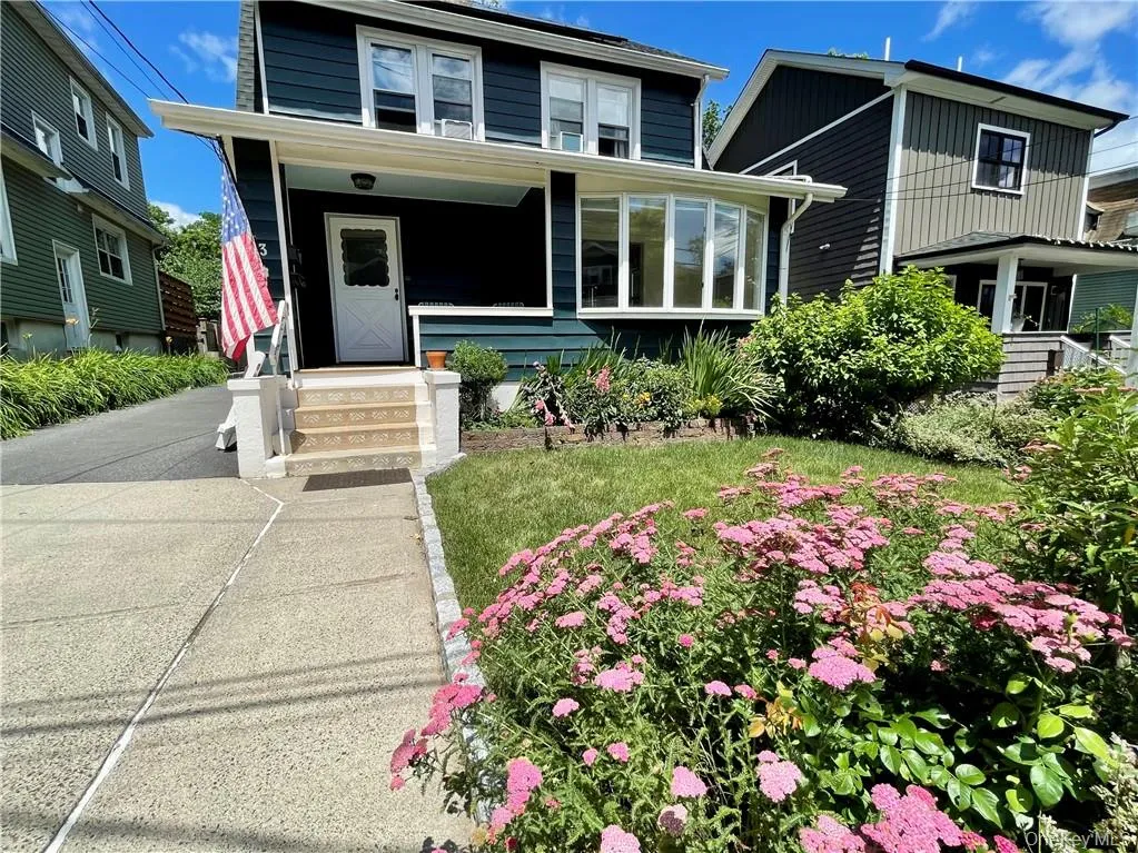 Front of home with perennial garden Front of home with perennial garden