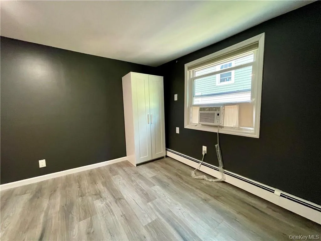 Bedroom #2, a few steps up to a private room with vinyl wood flooring, window a/c Bedroom #2, a few steps up to a private room with vinyl wood flooring, window a/c