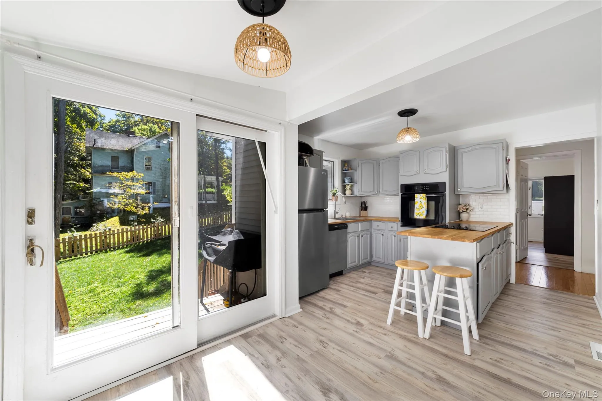 Large bright eat in kitchen with stainless steel appliances with sliding door to backyard Large bright eat in kitchen with stainless steel appliances with sliding door to backyard