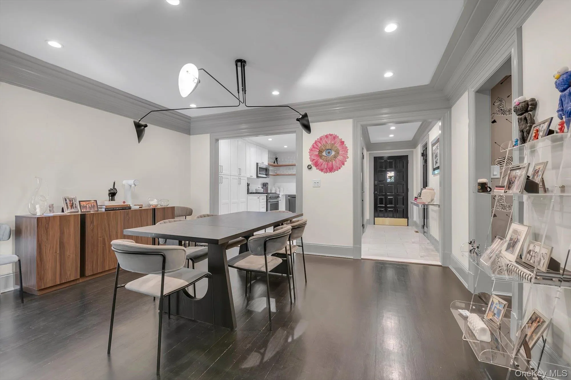 Spacious room featuring a contemporary linear chandelier, recessed lighting, and crown molding Spacious room featuring a contemporary linear chandelier, recessed lighting, and crown molding