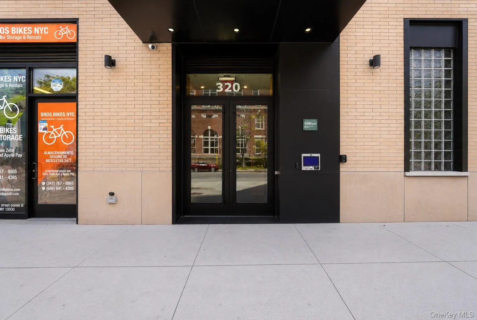 Building exterior featuring light-colored brickwork with black accents Building exterior featuring light-colored brickwork with black accents
